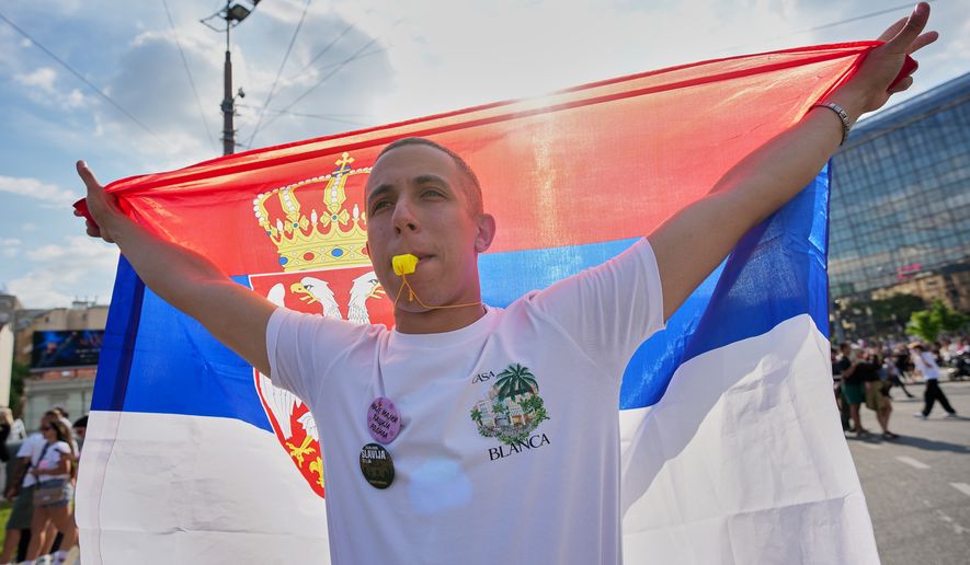 An anti-government protester blows a whistle before the first big rally of the year led by Serbia's protesting university students who are pushing for major political changes in the Balkan country run by President Aleksandar Vucic, in Belgrade, Serbia, Saturday, May. 23, 2026. (AP Photo/Darko Vojinovic)