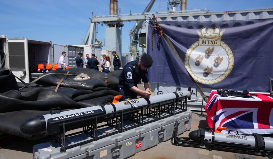 UK Royal Navy personnel inspect autonomous vehicles with sonar sensor that can detect and identify mines, on RFA Lyme Bay in territory of Gibraltar, on Friday, May 22, 2026. (AP Photo/Kwiyeon Ha)
