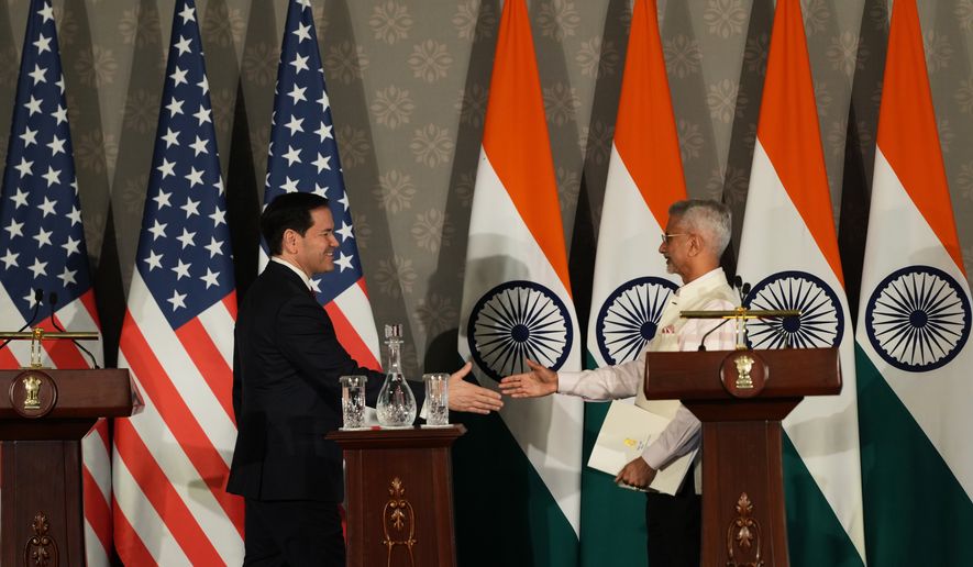 United States Secretary of State Marco Rubio, left, walks to shake hands with India's Minister of External Affairs S. Jaishankar after addressing a joint press conference following their talks in New Delhi, India, Sunday, May 24, 2026. (AP Photo/Manish Swarup)