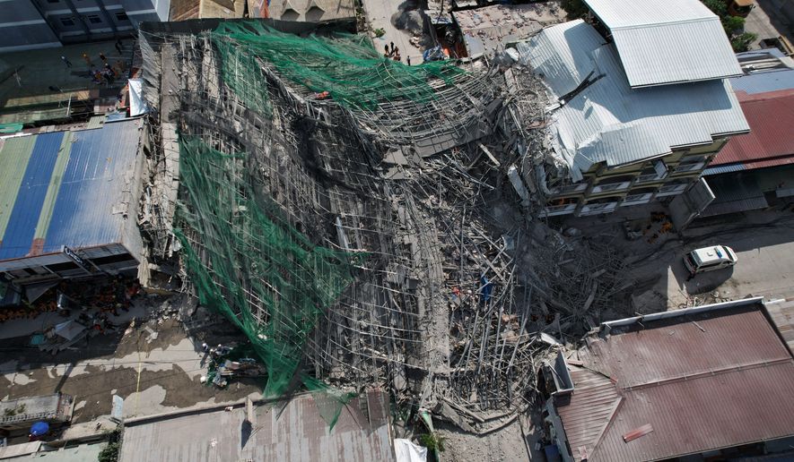 A collapsed building where multiple people are believed to be trapped in Angeles city in Pampanga province, north of Manila, Philippines Sunday, May 24, 2026. (AP Photo/Aaron Favila)