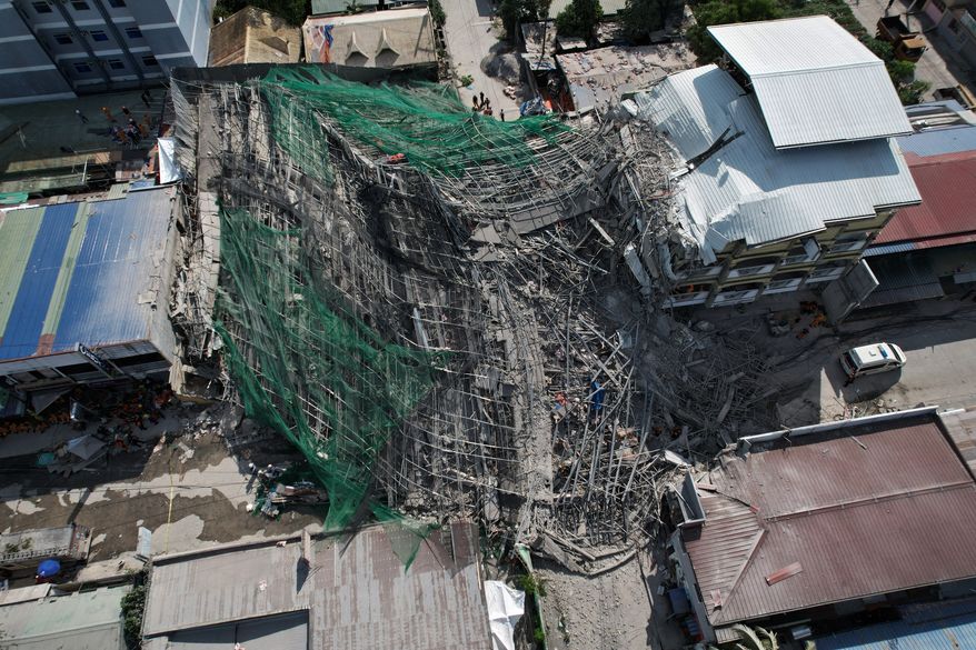A collapsed building where multiple people are believed to be trapped in Angeles city in Pampanga province, north of Manila, Philippines Sunday, May 24, 2026. (AP Photo/Aaron Favila)