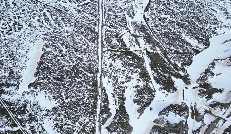 An aerial view shows melting snow on the slopes of Mount Parnassos at the Kelaria ski center in central Greece, on May 5, 2026. (AP Photo/Thanassis Stavrakis)