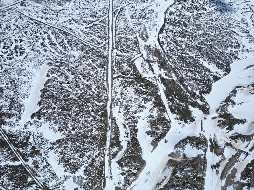 An aerial view shows melting snow on the slopes of Mount Parnassos at the Kelaria ski center in central Greece, on May 5, 2026. (AP Photo/Thanassis Stavrakis)