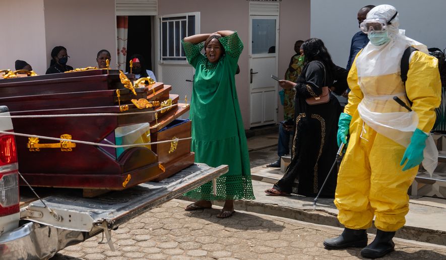 A woman mourns an Ebola victim as the coffin is take away for burial, at Sofepadi Hospital in Bunia, Congo, Saturday, May 23, 2026. (AP Photo/Moses Sawasawa)