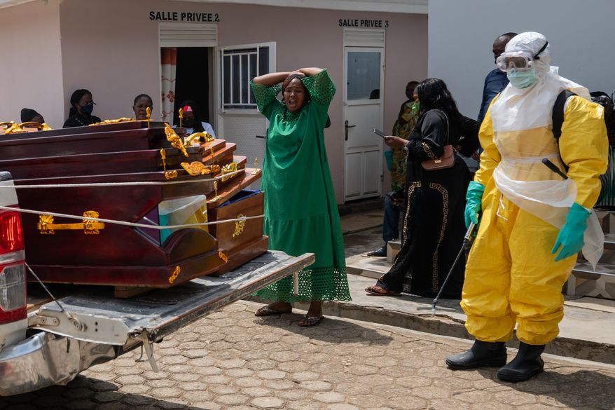 A woman mourns an Ebola victim as the coffin is take away for burial, at Sofepadi Hospital in Bunia, Congo, Saturday, May 23, 2026. (AP Photo/Moses Sawasawa)