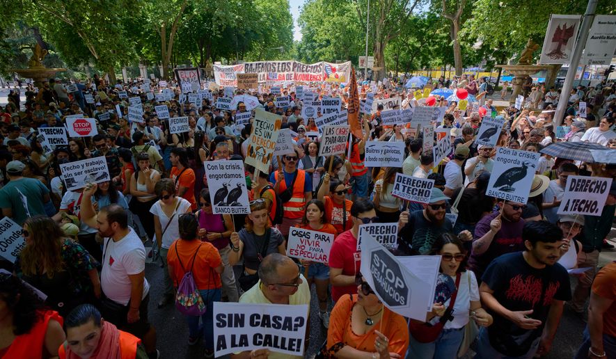 People take part during a protest in Madrid, Spain, on Sunday, May 24, 2026, against rising housing costs that are pricing many Spaniards out of the market amid a broader housing crisis in Spain. (AP Photo/Manu Fernandez)
