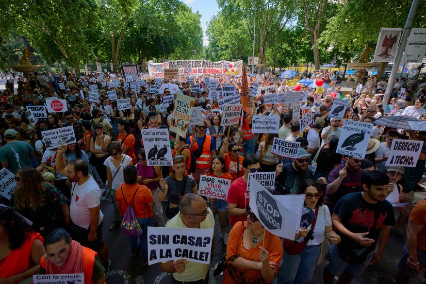 People take part during a protest in Madrid, Spain, on Sunday, May 24, 2026, against rising housing costs that are pricing many Spaniards out of the market amid a broader housing crisis in Spain. (AP Photo/Manu Fernandez)