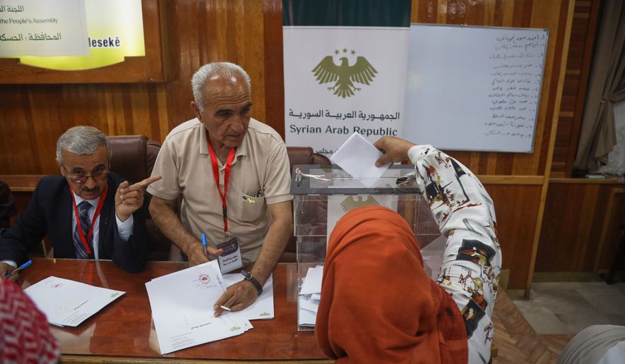 A voter casts a ballot during follow-up parliamentary elections in Hassakeh, northeastern Syria, Sunday, May 24, 2026. (AP Photo/Baderkhan Ahmad)