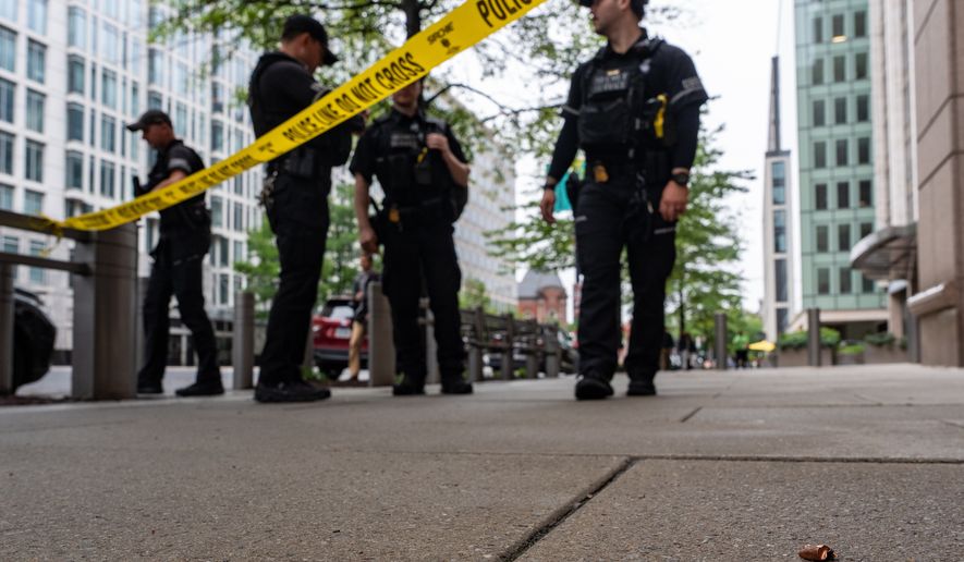 U.S. Secret Service Police officers place crime scene tape after a copper jacket of a bullet was found near the scene of a shooting close to the White House, Sunday, May 24, 2026, in Washington. (AP Photo/Alex Brandon)
