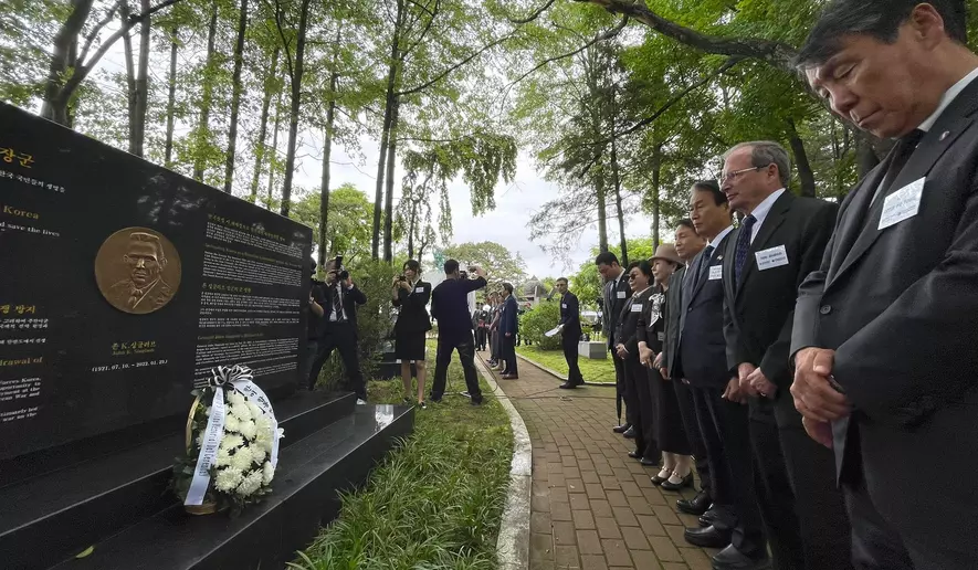 VIPs bow in front of the memorial to legendary US operative and soldier General John Singlaub, who famously opposed President Jimmy Carter's initiative to withdraw US troops from South Korea, at Imjingak, just south of the DMZ. (Andrew Salmon/The Washington Times)