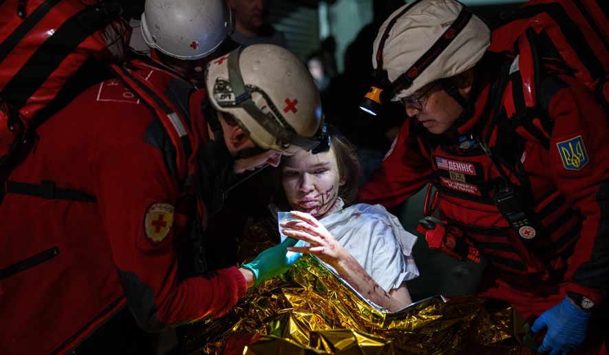Red Cross volunteers help an injured woman in a shelter after a Russian strike on a residential neighborhood in Kyiv, Ukraine, on Sunday, May 24, 2026. (AP Photo/Evgeniy Maloletka)