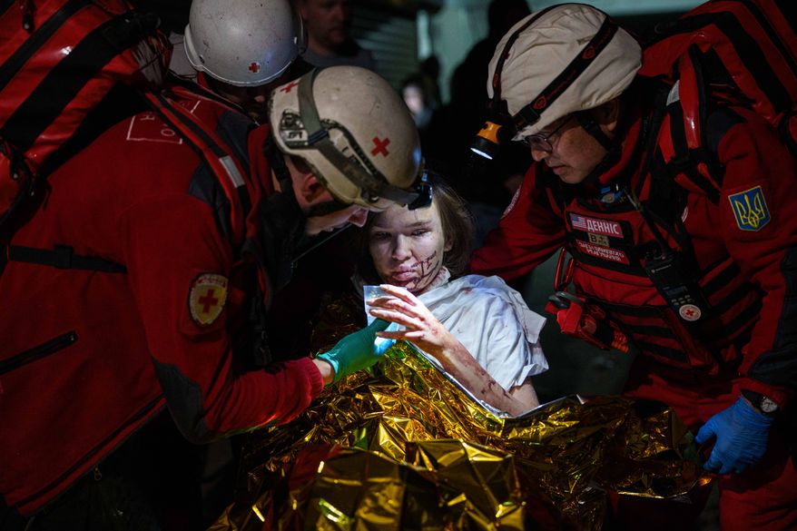 Red Cross volunteers help an injured woman in a shelter after a Russian strike on a residential neighborhood in Kyiv, Ukraine, on Sunday, May 24, 2026. (AP Photo/Evgeniy Maloletka)