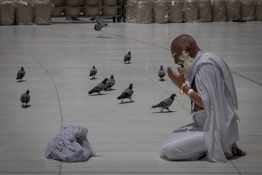 A Muslim pilgrim prays in front of the Kaaba, Islam's holiest site in the holy city of Mecca during the annual hajj pilgrimage, Saudi Arabia, Sunday, May 24, 2026. (AP Photo/Altaf Qadri)