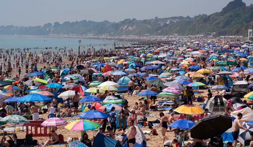 People visit Bournemouth beach, south England, Monday May 25, 2026. (Andrew Matthews/PA via AP)