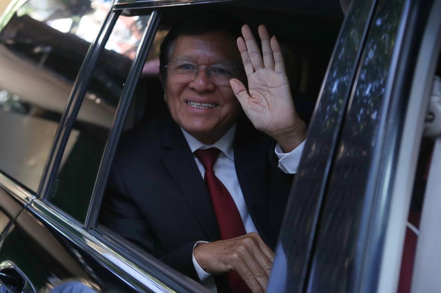 FILE -Former President of Cambodia National Rescue Party, Kem Sokha, greets from his car in front of his house in Phnom Penh, Cambodia, Friday, March 3, 2023. (AP Photo/Heng Sinith, File)