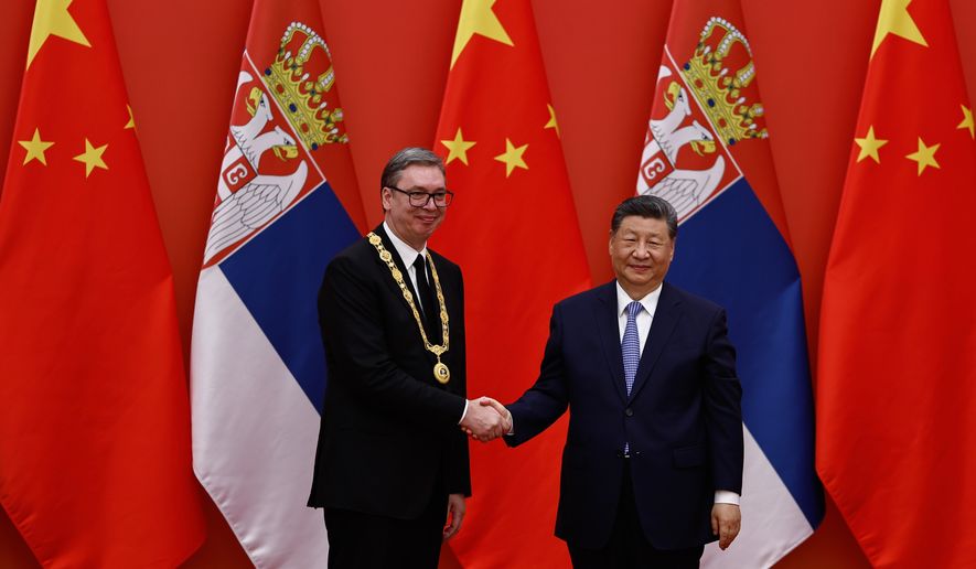 Chinese President Xi Jinping shakes hands with Serbian President Aleksandar Vucic after he received the Friendship Medal of the People's Republic of China, at the Great Hall of the People, in Beijing, China Monday, May 25, 2026. (Tingshu Wang, Pool Photo via AP)