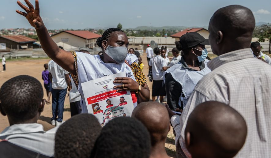 Vanny Birungi, a Red Cross volunteer, speaks to people during a public sensitisation campaign amid the Ebola outbreak in Bunia, Congo, Monday, May 25, 2026. (AP Photo/Moses Sawasawa)