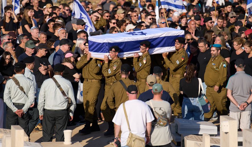 Israeli soldiers carry the casket of Staff sergeant Noam Hamburger, who was killed in a Lebanese drone attack on northern Israel, during his funeral in Atlit, Israel, Sunday, May 24, 2026. (AP Photo/Ariel Schalit)