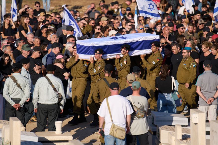 Israeli soldiers carry the casket of Staff sergeant Noam Hamburger, who was killed in a Lebanese drone attack on northern Israel, during his funeral in Atlit, Israel, Sunday, May 24, 2026. (AP Photo/Ariel Schalit)