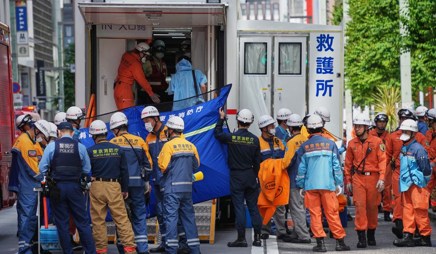 First responders gather near the scene after a person allegedly sprayed a substance that caused an odor, in Tokyo, Japan, Monday, May 25, 2026. (AP Photo/Eugene Hoshiko)