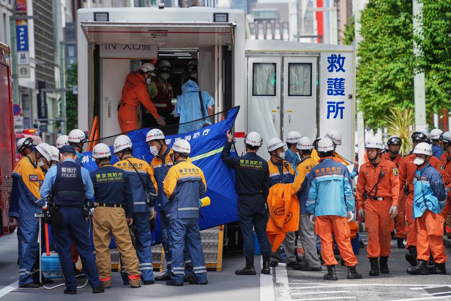 First responders gather near the scene after a person allegedly sprayed a substance that caused an odor, in Tokyo, Japan, Monday, May 25, 2026. (AP Photo/Eugene Hoshiko)