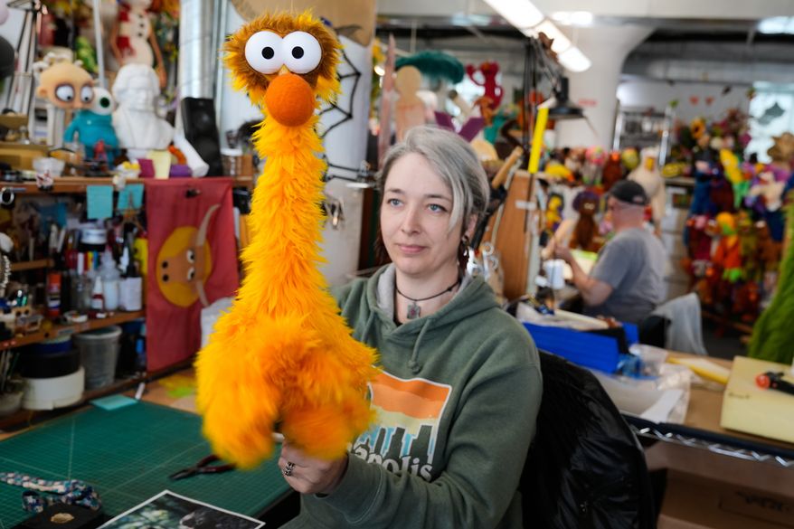 Sierra Schoening, a senior puppet builder, demonstrates how to maneuver a puppet she built at Jim Henson's Creature Shop in New York, Wednesday, May 13, 2026. (AP Photo/Seth Wenig)