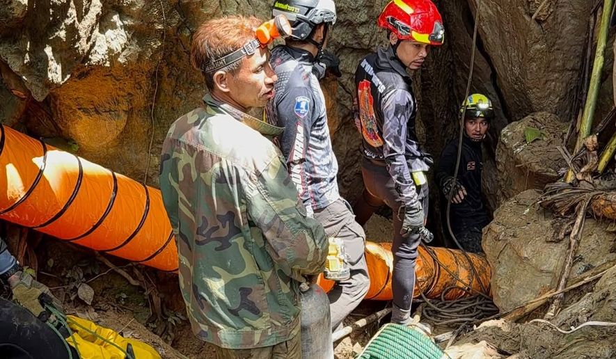 In this release Metta Tham Rescue Kalasin, rescuers work to reach seven people who have been trapped in a cave in Xaisomboun province, Laos, Monday, May 25, 2026. (Metta Tham Rescue Kalasin via AP)