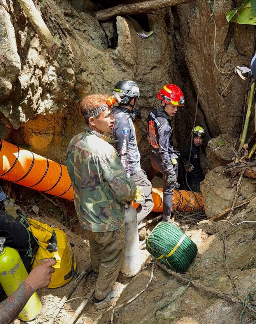 In this release Metta Tham Rescue Kalasin, rescuers work to reach seven people who have been trapped in a cave in Xaisomboun province, Laos, Monday, May 25, 2026. (Metta Tham Rescue Kalasin via AP)
