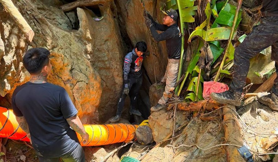 In this release Metta Tham Rescue Kalasin, rescuers work to reach seven people who have been trapped in a cave in Xaisomboun province, Laos, Monday, May 25, 2026. (Metta Tham Rescue Kalasin via AP)