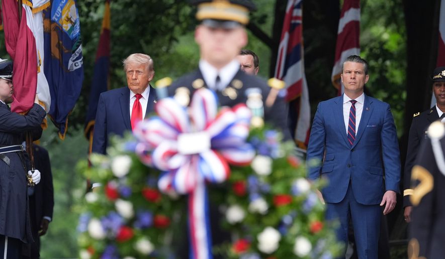 President Donald Trump, from left, alongside Vice President JD Vance, obstructed, and Defense Secretary Pete Hegseth, stand before placing a wreath at the Tomb of the Unknown Soldier in Arlington National Cemetery on Memorial Day, Monday, May 25, 2026, in Arlington, Va. (AP Photo/Alex Brandon)