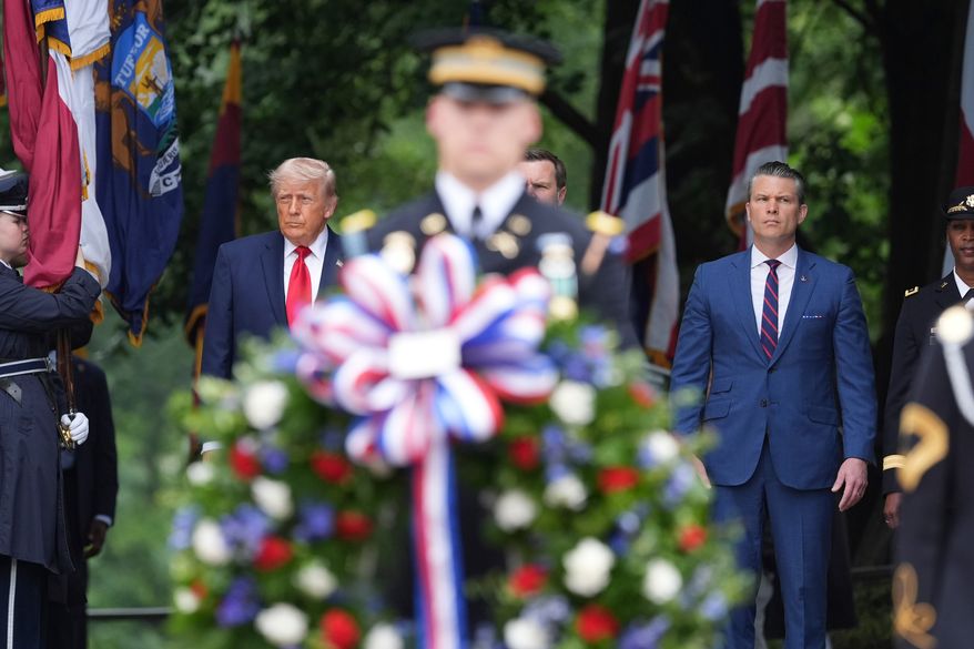 President Donald Trump, from left, alongside Vice President JD Vance, obstructed, and Defense Secretary Pete Hegseth, stand before placing a wreath at the Tomb of the Unknown Soldier in Arlington National Cemetery on Memorial Day, Monday, May 25, 2026, in Arlington, Va. (AP Photo/Alex Brandon)