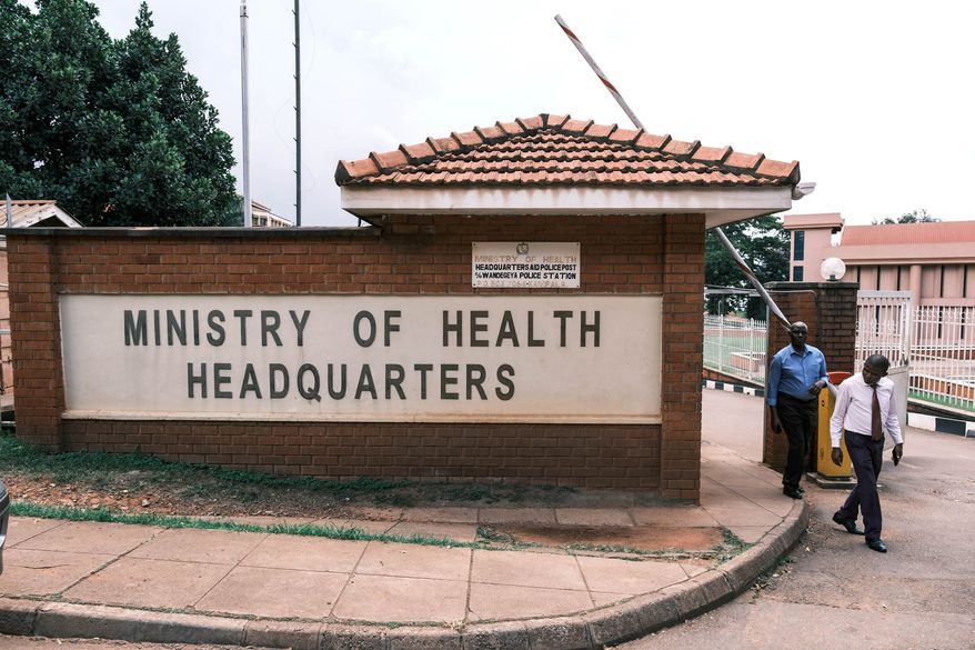 People walk out of the Ministry of Health's Headquarters in Kampala, Uganda, Tuesday, May 19, 2026. (AP Photo/Hajarah Nalwadda)
