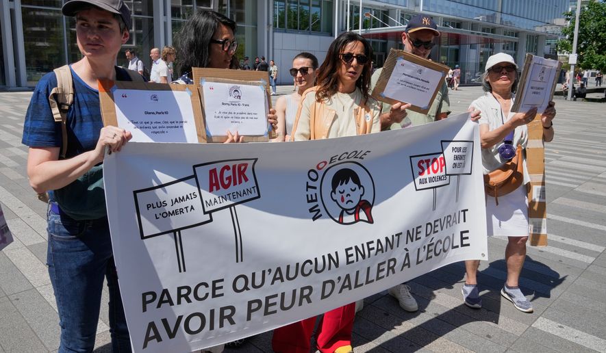 Members and supporters of the #METooEcole (#METooSchool) movement stage a protest to draw attention to a child abuse scandal in France in front of the courthouse in Paris on Tuesday May 26, 2026. The banner reads, in French, "Because no child should ever be afraid to go to school." (AP Photo/Michel Euler)
