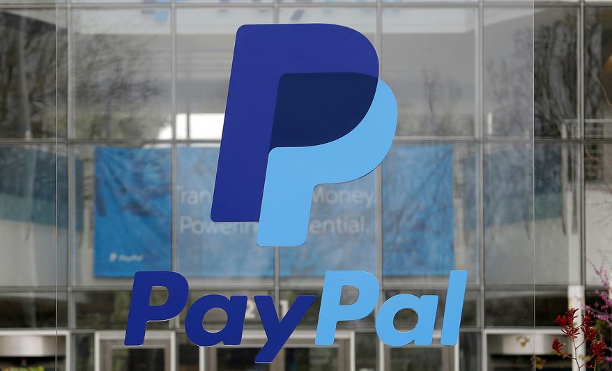FILE - The PayPal logo hangs displayed outside their company headquarters on March 10, 2015, in San Jose, Calif. (AP Photo/Jeff Chiu, File)