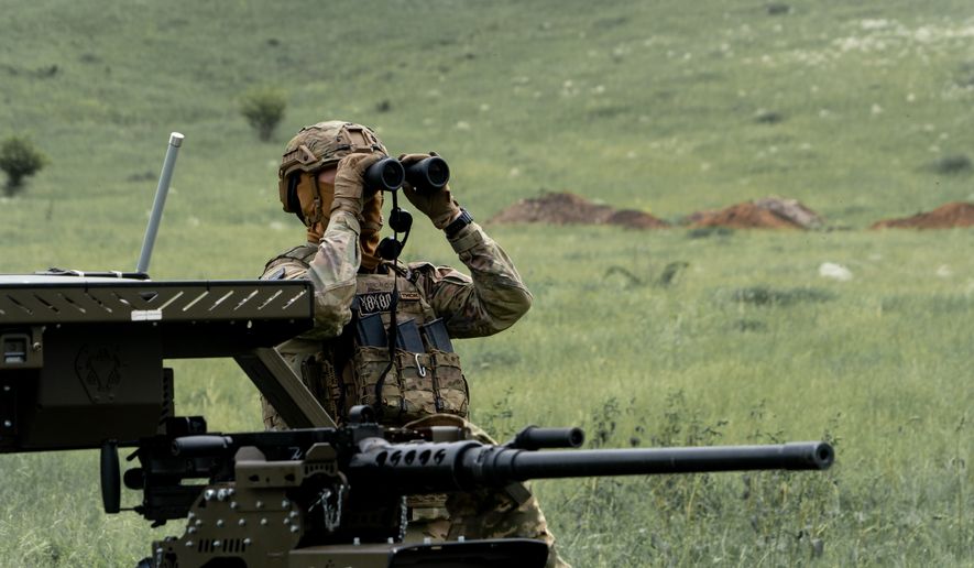 A Ukrainian serviceman of the Cerberus Ground Unmanned Systems Company of the 60th Separate Mechanized Brigade, Third Army Corps, conducts a drill with a combat ground drone during a training at the polygon in Kharkiv region, Ukraine, Sunday, May 24, 2026. (AP Photo/Andrii Marienko)
