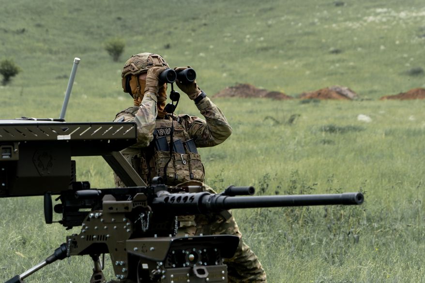 A Ukrainian serviceman of the Cerberus Ground Unmanned Systems Company of the 60th Separate Mechanized Brigade, Third Army Corps, conducts a drill with a combat ground drone during a training at the polygon in Kharkiv region, Ukraine, Sunday, May 24, 2026. (AP Photo/Andrii Marienko)