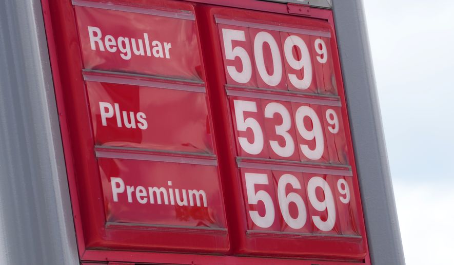 The per-gallon prices for the various grades of gasoline available at a gas station are displayed on a sign above the pumps, Sunday, May 24, 2026, in southeast Denver. (AP Photo/David Zalubowski)