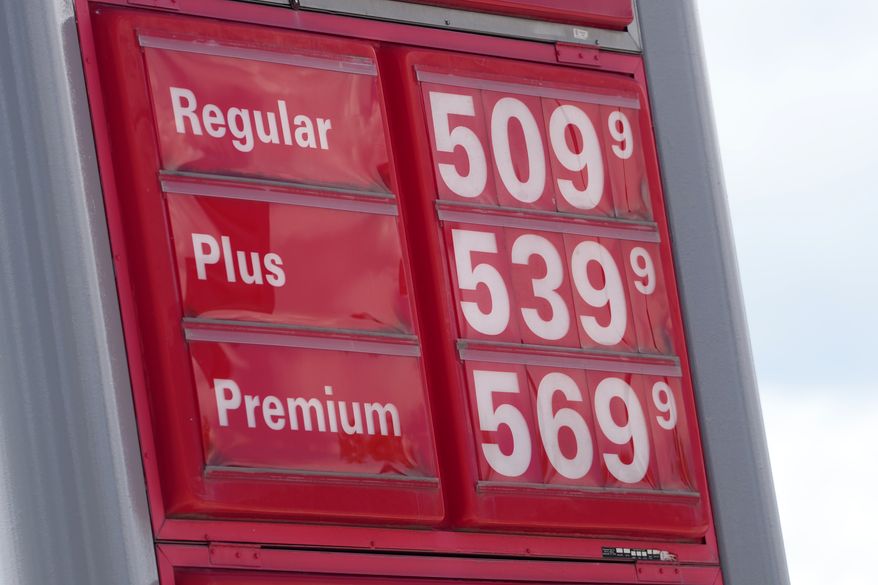 The per-gallon prices for the various grades of gasoline available at a gas station are displayed on a sign above the pumps, Sunday, May 24, 2026, in southeast Denver. (AP Photo/David Zalubowski)