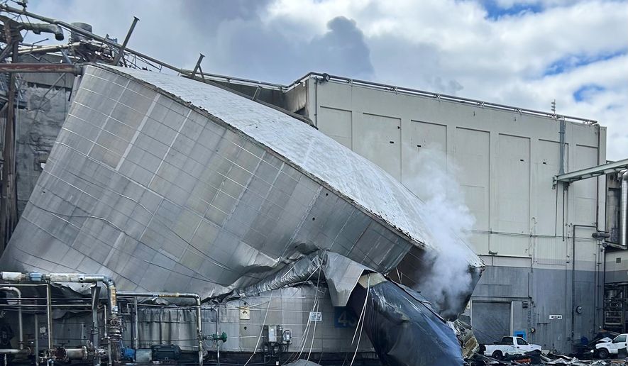 This photo provided by the City of Longview, Wash., shows structural damage to the Nippon Dynawave Packaging Co., after a tank containing hazardous liquid imploded, on Tuesday, May 26, 2026 in Longview, Wash. (City of Longview via AP)