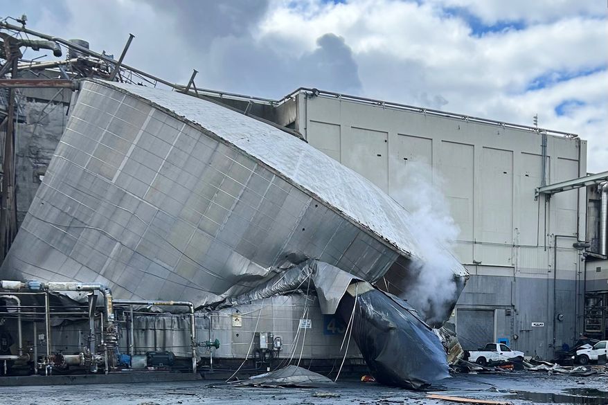 This photo provided by the City of Longview, Wash., shows structural damage to the Nippon Dynawave Packaging Co., after a tank containing hazardous liquid imploded, on Tuesday, May 26, 2026 in Longview, Wash. (City of Longview via AP)