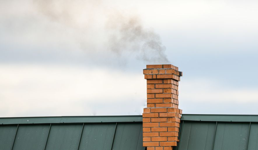 Smoke coming out of a house chimney. File photo credit: KAY4YK via Shutterstock.
