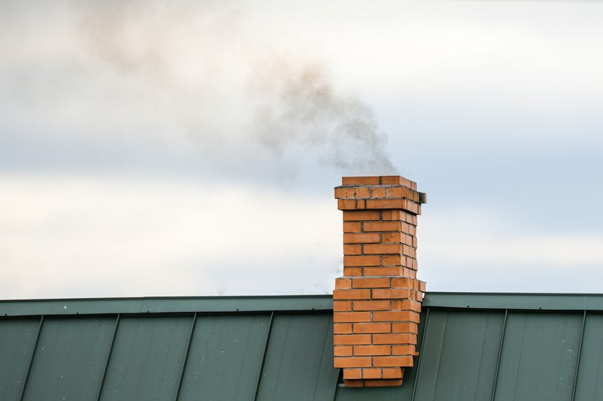 Smoke coming out of a house chimney. File photo credit: KAY4YK via Shutterstock.