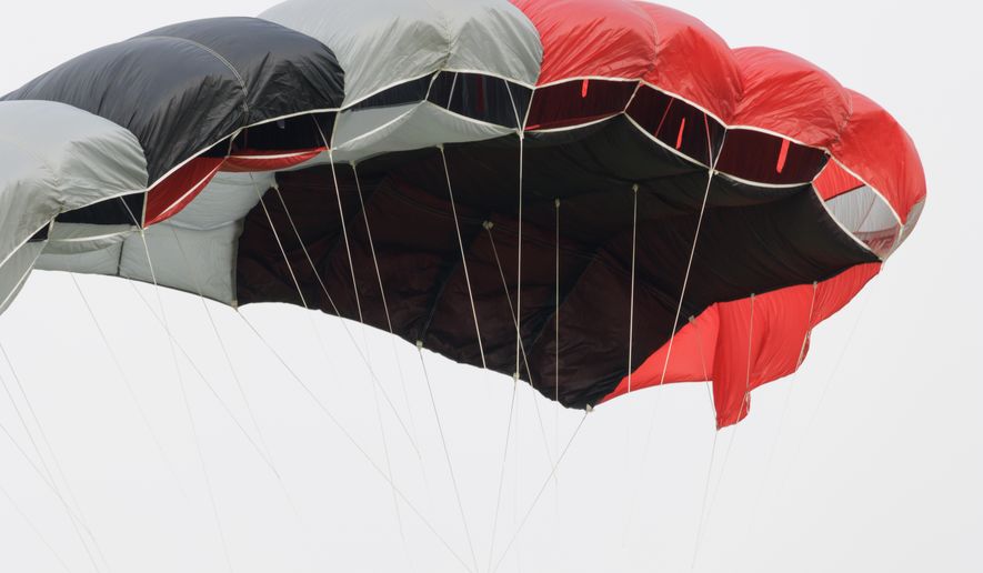 Red, black and white skydiving parachute canopy. File photo credit: Applejak via Shutterstock.