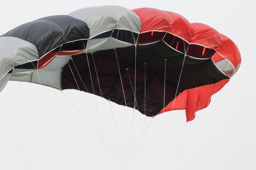 Red, black and white skydiving parachute canopy. File photo credit: Applejak via Shutterstock.
