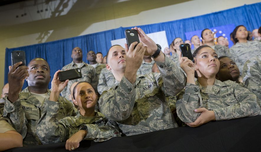 Members of the military use their smartphones to record President Barack Obama speaking at U.S. Central Command (CENTCOM) at MacDill Air Force Base, Fla., Wednesday, Sept. 17, 2014. (AP Photo/Pablo Martinez Monsivais) ** FILE **