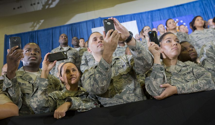 Members of the military use their smartphones to record President Barack Obama speaking at US Central Command (CentCom) at MacDill Air Force Base, Fla., Wednesday, Sept. 17, 2014. Obama visited CentCom and was updated on the ongoing military campaigns in Iraq and Syria. (AP Photo/Pablo Martinez Monsivais) **FILE**