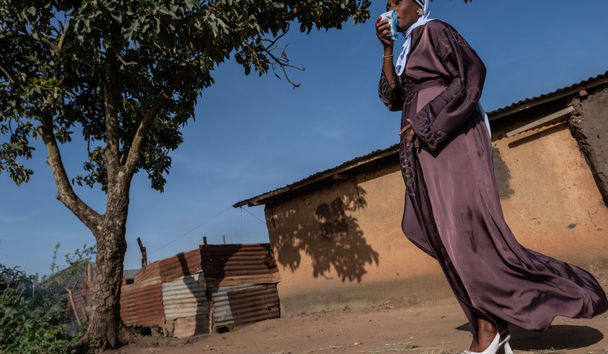 A Muslim woman walks towards the prayer grounds at Sayo Muhamed School to perform Eid al-Adha prayers amid an Ebola outbreak in Bunia, Congo, Wednesday, May 27, 2026. (AP Photo/Moses Sawasawa)