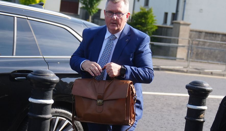 Jeffrey Donaldson arrives at Newry Crown Court, England, where he and his wife Eleanor Donaldson are accused of historical sexual offences, on Wednesday May 27, 2026. (Brian Lawless/PA via AP)