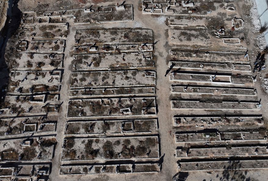 FILE - An aerial view of a mass grave where are buried those who were killed by the sarin struck during a 2013 chemical weapons attack that was blamed on then President Bashar Assad's forces, in Zamalka neighbourhood, on the outskirts of Damascus, Syria, Wednesday, Dec. 25, 2024. (AP Photo/Hussein Malla, file)