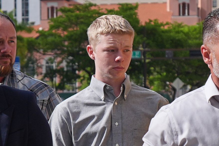 Timothy Hudson, center, charged with sexually assaulting and killing his 18-year-old stepsister on a Carnival Cruise ship, arrives for a hearing at the The James Lawrence King Federal Justice Building, Wednesday, May 27, 2026, in Miami. (AP Photo/Rebecca Blackwell)